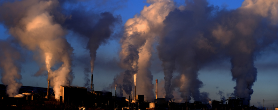 image of industrial criteria air pollutants. Smoke coming from stacks at a facility.